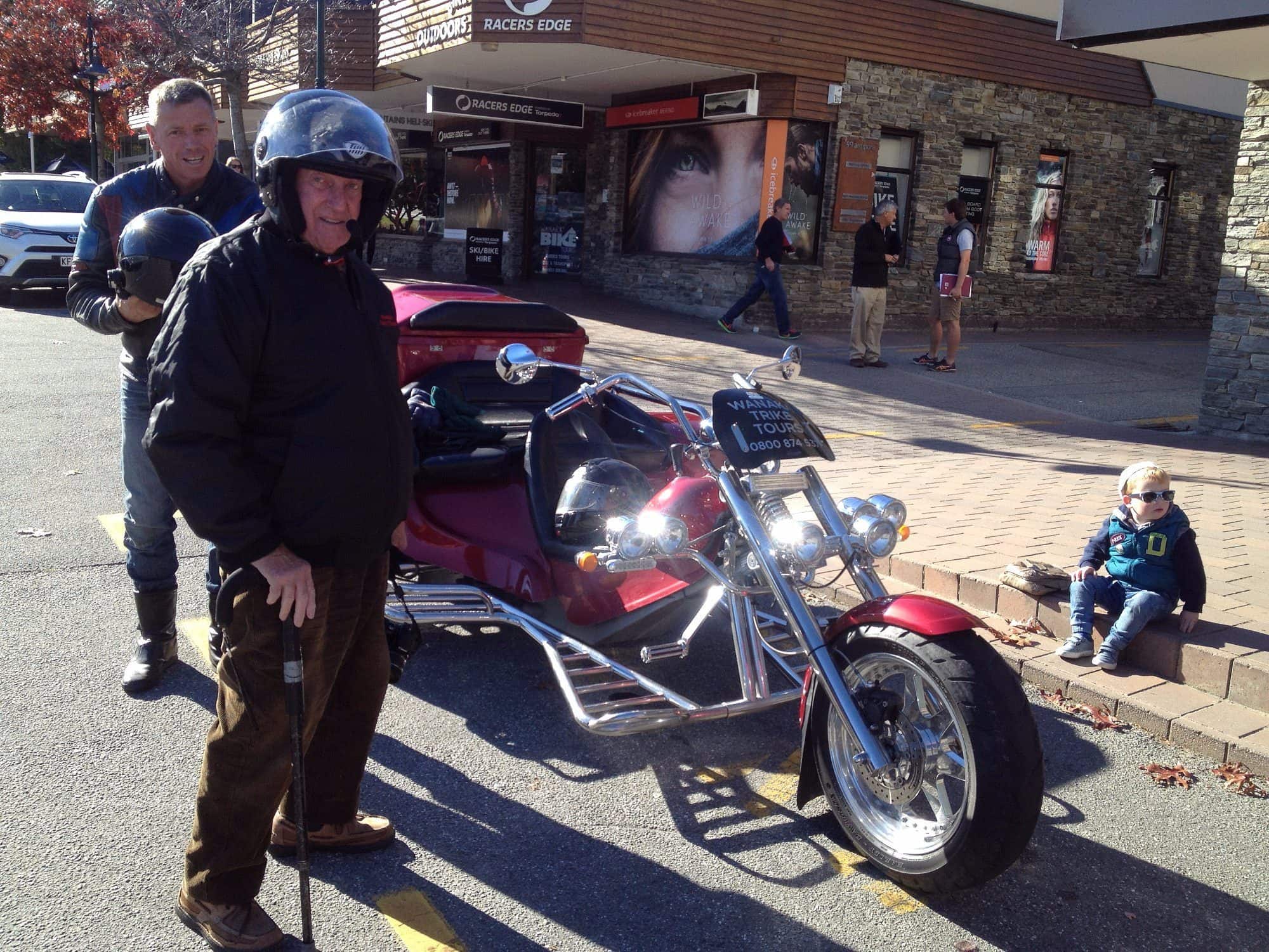 Guide beside a trike outside a historic pub