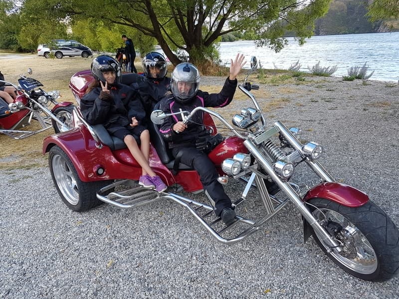 Trike with three guests, lake behind